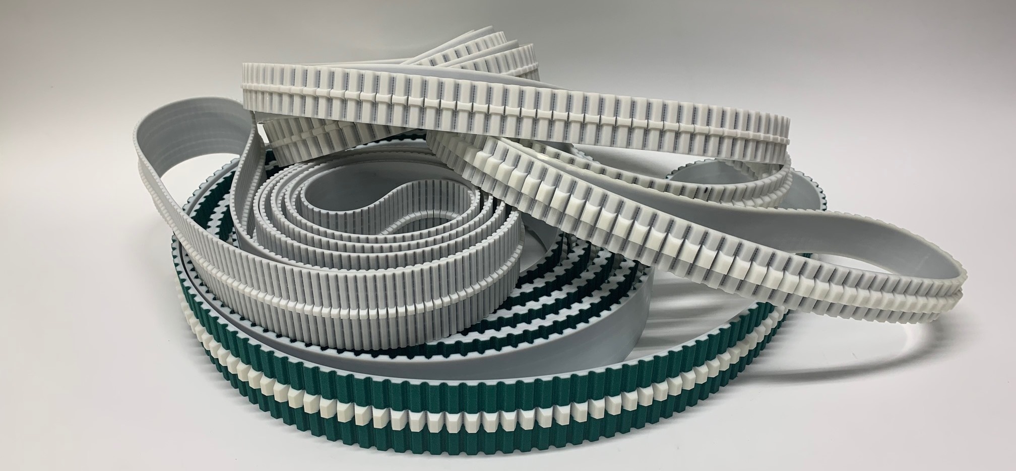 Timing belts with tracking profile